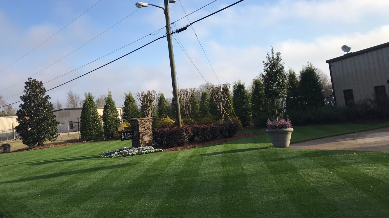 lawn care service Our lawn care service office in the Macon & Warner Robins area. The lawn is dark green and striped. It is maintained by our lawn care treatment specialist.